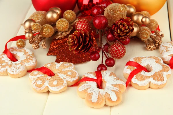 Christmas cookies and decorations on color wooden background — Stock Photo, Image