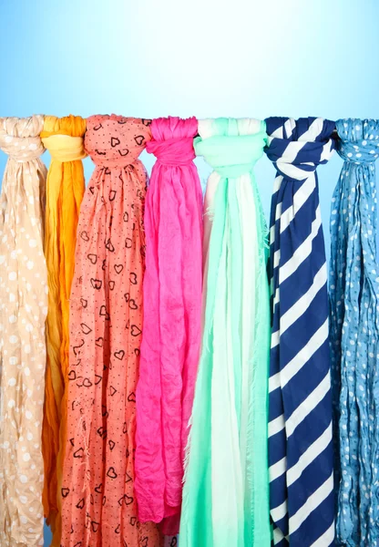 Colored scarves on blue background — Stock Photo, Image