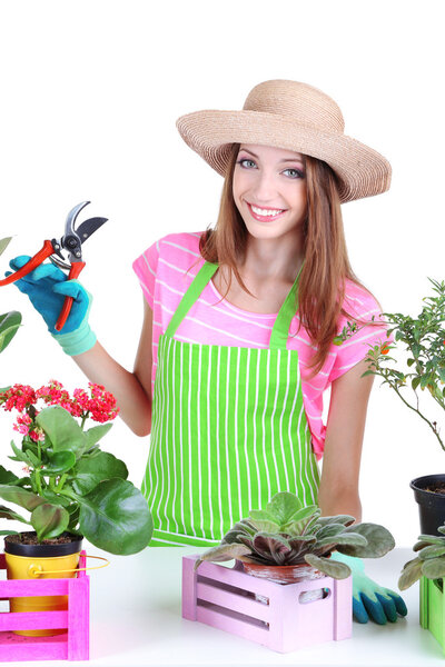 Beautiful girl gardener with flowers isolated on white