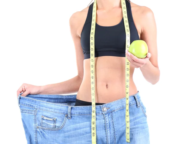 Slim girl in big jeans isolated on white — Stock Photo, Image