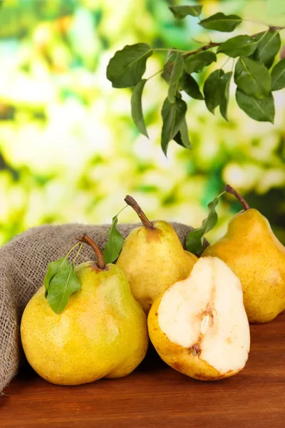 Juicy pears on table on bright background — Stock Photo, Image