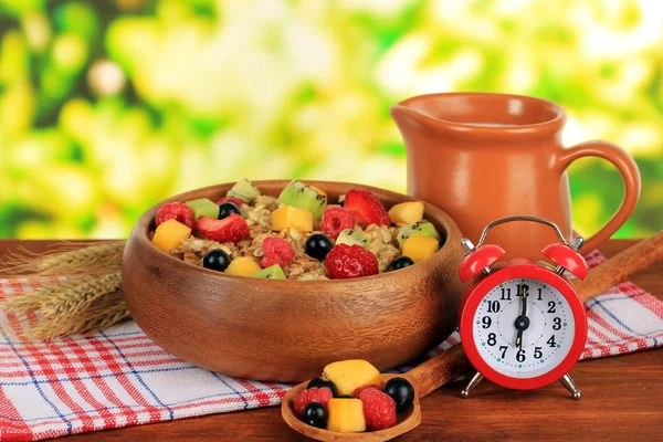 Oatmeal with fruits on table on bright background — Stock Photo, Image