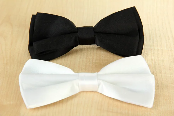 Black and white bow ties on wooden background — Stock Photo, Image