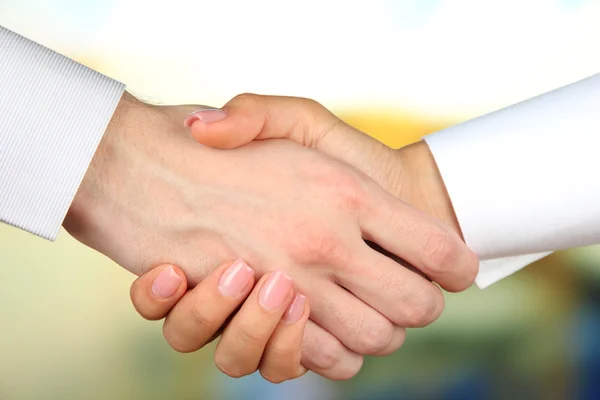 Business handshake on bright background — Stock Photo, Image