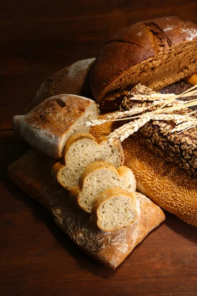 Much bread on wooden board — Stock Photo, Image