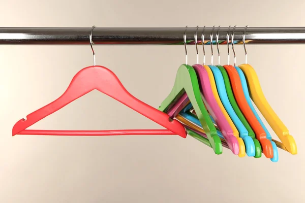 Colorful clothes hangers on gray background — Stock Photo, Image