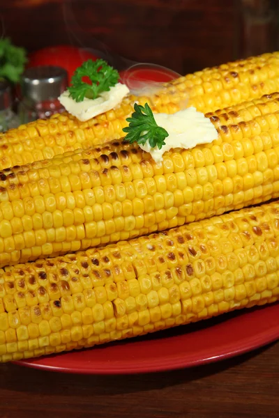 Delicious golden grilled corn with butter on table on wooden background — Stock Photo, Image