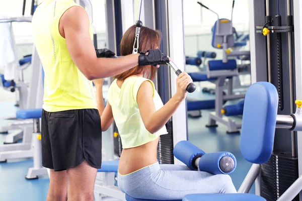 Girl and trainer in gym — Stock Photo, Image