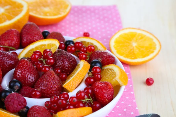 Useful fruit salad in plate on wooden table close-up — Stock Photo, Image