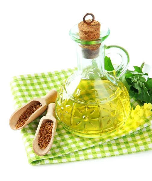 Jar of mustard oil and seeds with mustard flower on wooden background — Stock Photo, Image