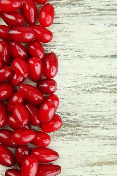 Fresh cornel berries on wooden background — Stock Photo, Image