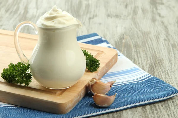 Sour cream in pitcher on table close-up — Stock Photo, Image