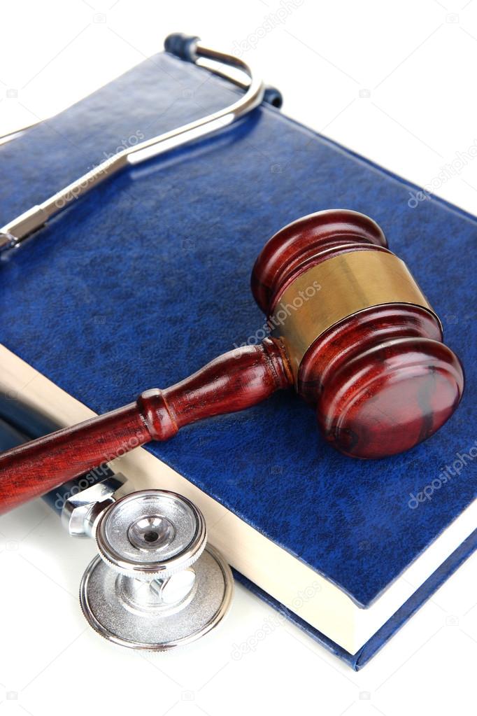 Medicine law concept. Gavel and stethoscope on book close up