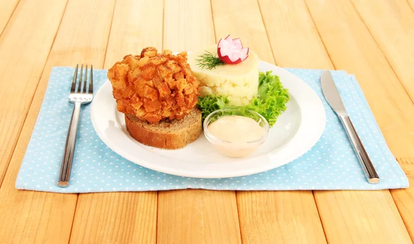 Chicken Kiev on croutons with mashed potatoes, on wooden background — Stock Photo, Image