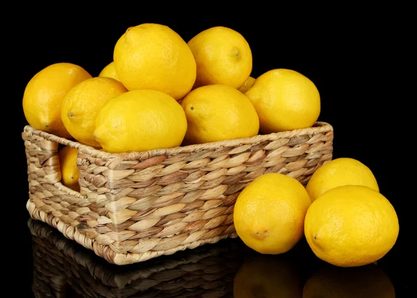 Ripe lemons in wicker basket isolated on black — Stock Photo, Image