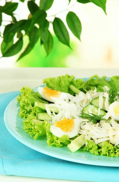 Delicious salad with eggs, cabbage and cucumbers on table — Stock Photo, Image