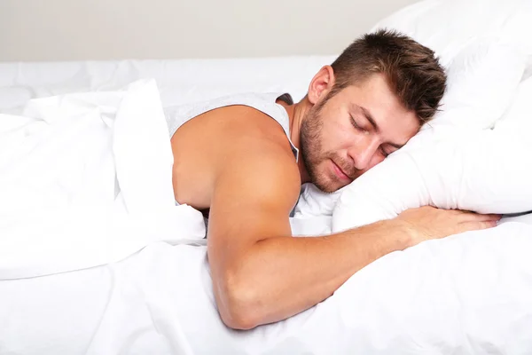 Bonito jovem homem na cama — Fotografia de Stock