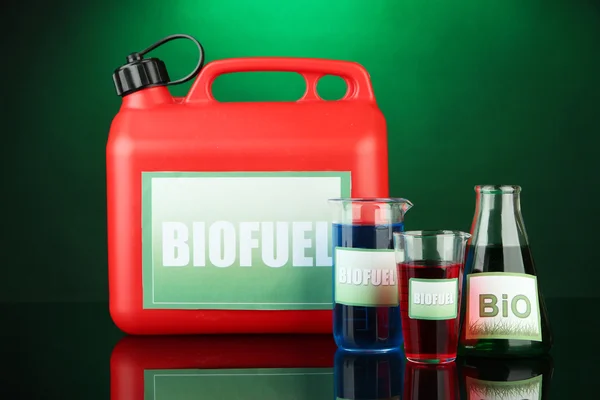 Bio fuels in canister and vials on green background — Stock Photo, Image