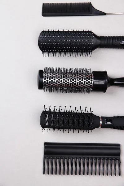 Black combs on gray background — Stock Photo, Image