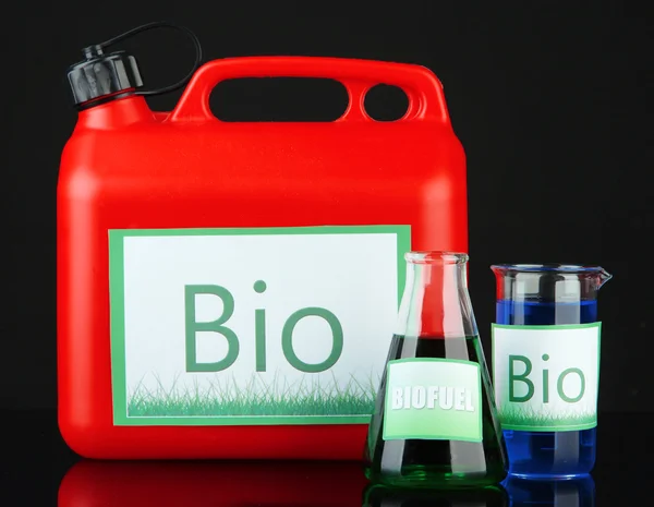 Bio fuels in canister and vials on black background — Stock Photo, Image