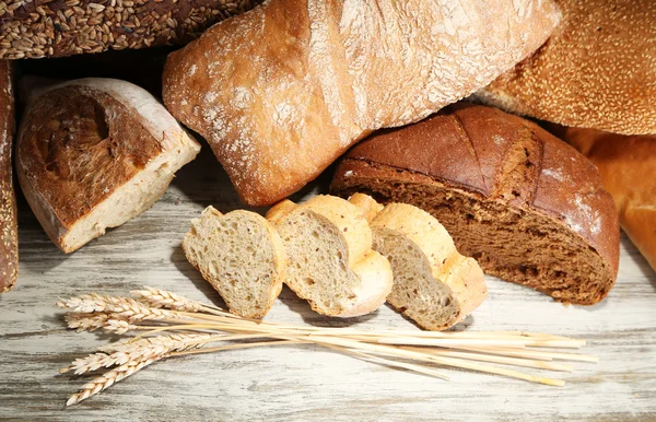 Much bread on wooden board — Stock Photo, Image