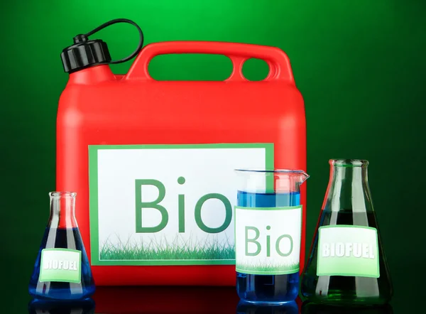 Bio fuels in canister and vials on green background — Stock Photo, Image