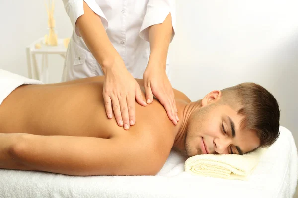 Young man having back massage close up — Stock Photo, Image