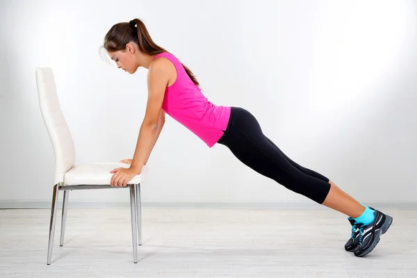 Young beautiful fitness girl doing yoga exercise isolated on white — Stock Photo, Image