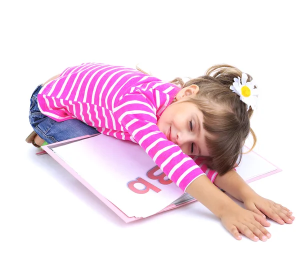 Little girl sitting on floor with book isolated on white — Stock Photo, Image