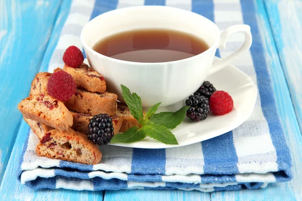 Tazza di tè con biscotti e bacche sul tavolo primo piano — Foto Stock