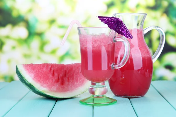 Glass of fresh watermelon juice, on wooden table, on bright background — Stock Photo, Image