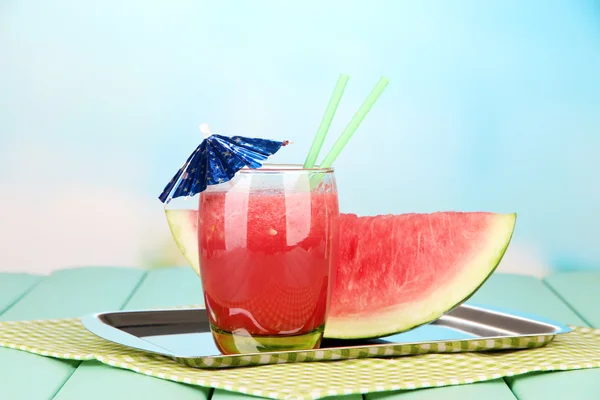 Glass of fresh watermelon juice, on wooden table, on bright background — Stock Photo, Image