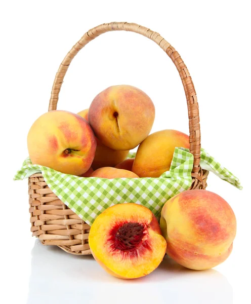 Ripe sweet peaches in wicker basket, isolated on white — Stock Photo, Image