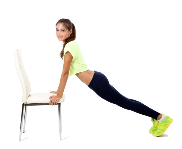 Menina bonita fazendo exercícios isolados no branco — Fotografia de Stock