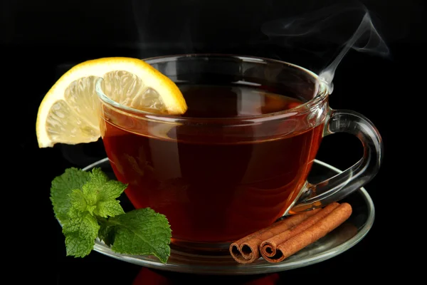 Cup of tea with lemon isolated on black