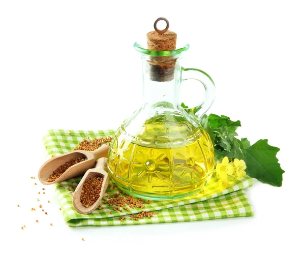 Jar of mustard oil and seeds with mustard flower on wooden background — Stock Photo, Image