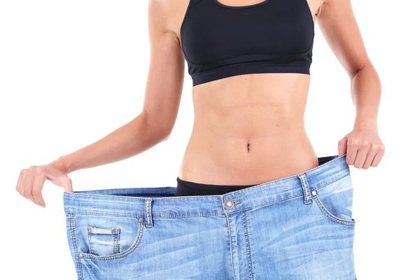 Menina magro em jeans grandes isolado em branco — Fotografia de Stock