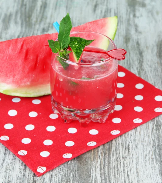Glass of fresh watermelon juice, on wooden table, on wooden background — Stock Photo, Image