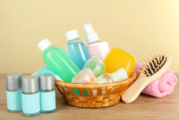 Hotel amenities kit on table on beige background — Stock Photo, Image