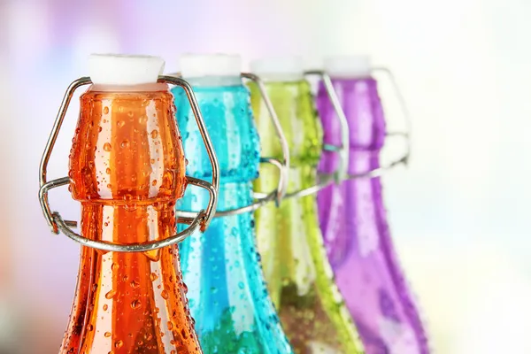 Colorful bottles on bright background — Stock Photo, Image