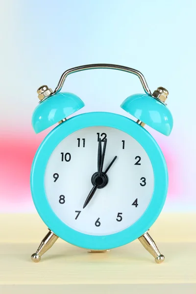 Alarm clock on table on light background — Stock Photo, Image