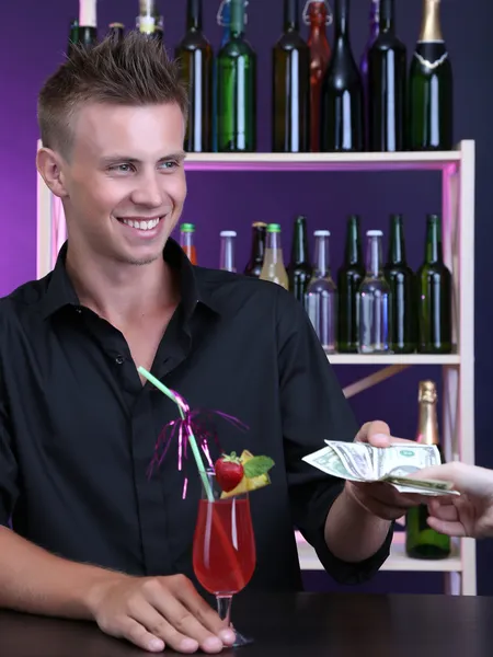 Portrait of handsome barman receiving tips from client — Stock Photo, Image