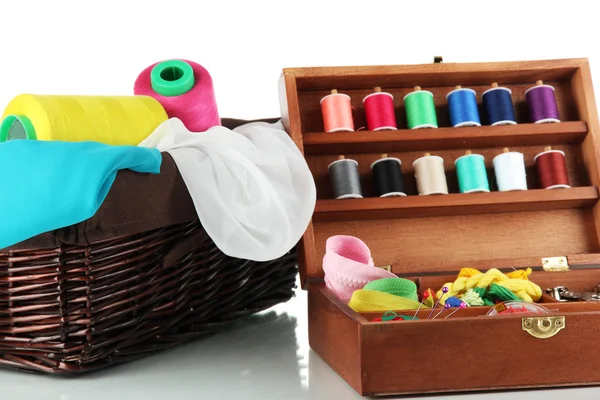 Sewing kit in wooden box and basket with cloth isolated on white — Stock Photo, Image