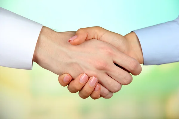 Business handshake on bright background — Stock Photo, Image