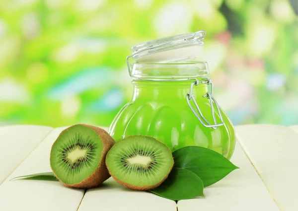 Pot voor jam kiwi op houten tafel op natuurlijke achtergrond — Stockfoto