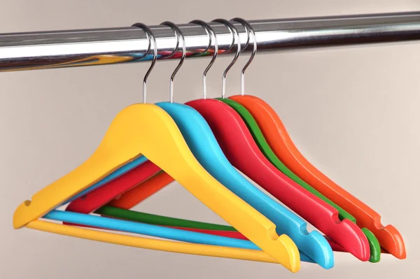 Colorful clothes hangers on gray background — Stock Photo, Image