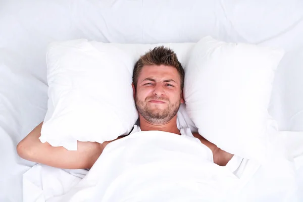 Handsome young man in bed — Stock Photo, Image