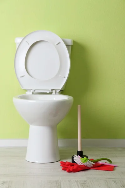 White toilet bowl and cleaner things in a bathroom — Stock Photo, Image