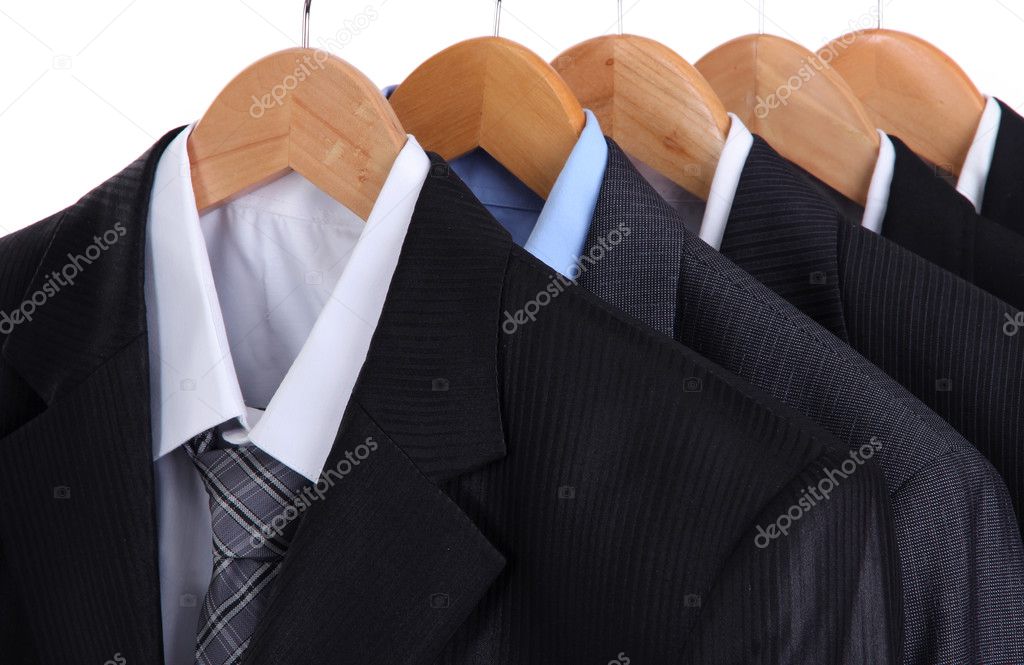 Suits with shirts on hangers on white background