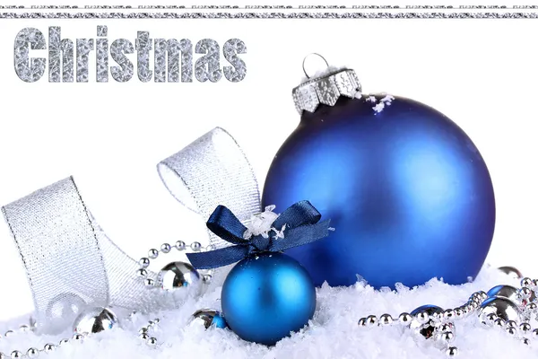 Beautiful blue Christmas balls on snow, isolated on white — Stock Photo, Image